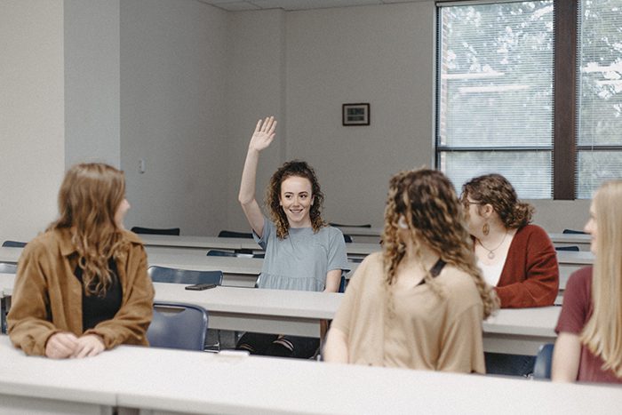Girl Raising Hand in Class