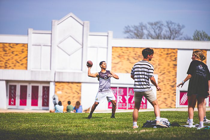 Two Students Throwing Football